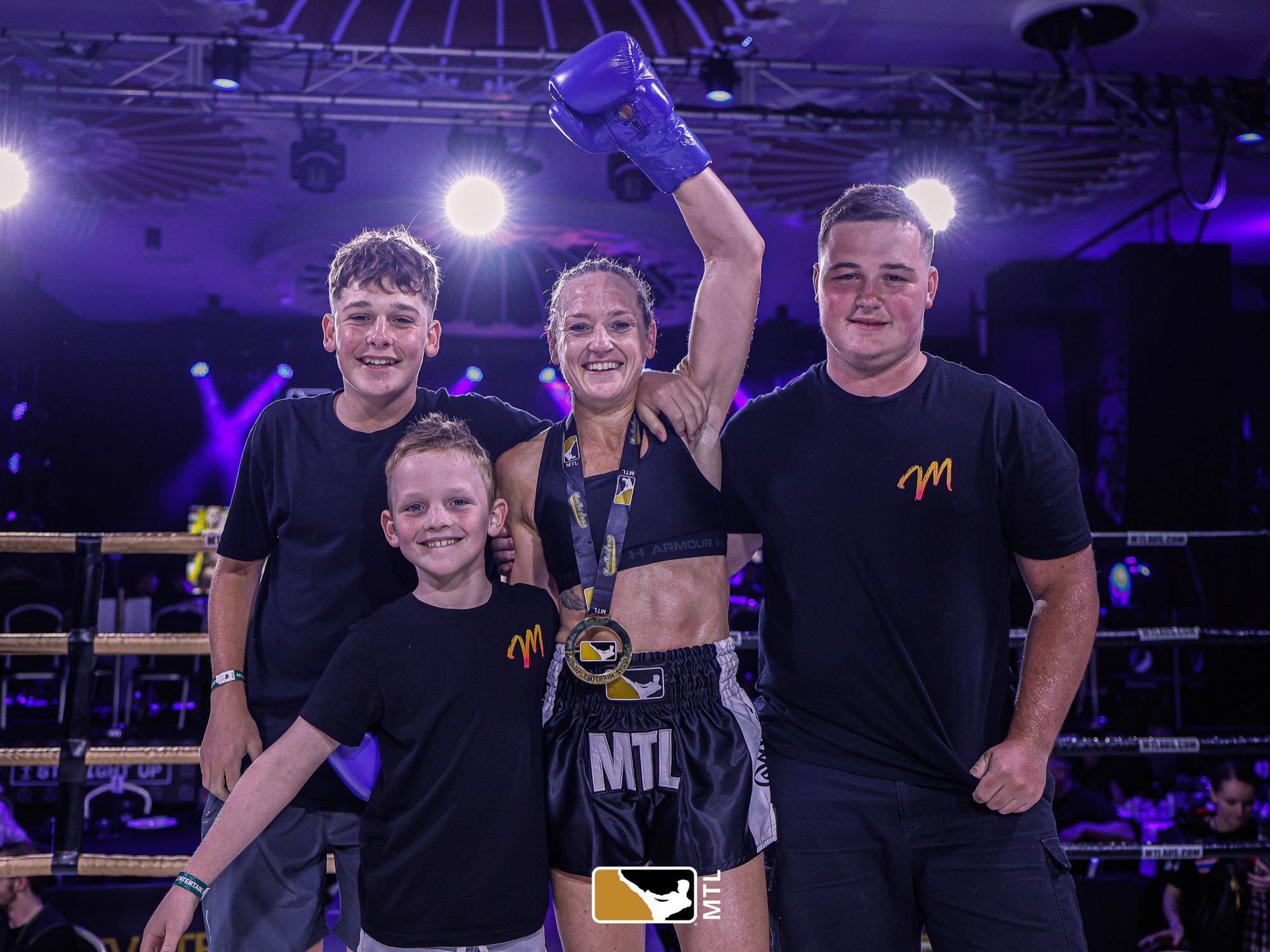 Mardi celebrating a win in the ring with her three sons